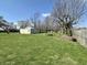 Spacious backyard with mature trees, a fire pit, and plenty of room for recreation and relaxation at 1210 W Grant St, Thorntown, IN 46071