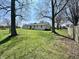 Expansive backyard featuring mature trees and a swing set, perfect for outdoor activities and relaxation at 1210 W Grant St, Thorntown, IN 46071