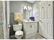 Well-lit bathroom featuring marble floors, a white vanity, toilet, and a shower curtain at 1210 W Grant St, Thorntown, IN 46071