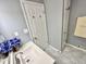 Updated bathroom with light gray walls, white cabinets and modern fixtures at 1210 W Grant St, Thorntown, IN 46071
