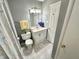 Well-lit bathroom featuring marble floors, a white vanity, toilet, and a shower curtain at 1210 W Grant St, Thorntown, IN 46071