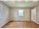Sunlit bedroom featuring hardwood floors and a window overlooking the property at 1210 W Grant St, Thorntown, IN 46071