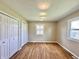 Well-lit bedroom featuring hardwood floors, dual closets, and windows at 1210 W Grant St, Thorntown, IN 46071