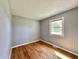 Bright bedroom featuring hardwood floors, neutral paint, and a window with a pleasant outdoor view at 1210 W Grant St, Thorntown, IN 46071
