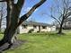 Inviting single-story home with a brick facade, complemented by a lush green lawn and mature shade trees at 1210 W Grant St, Thorntown, IN 46071
