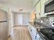 Bright kitchen with stainless appliances, white cabinets, and adjacent door to backyard at 1210 W Grant St, Thorntown, IN 46071