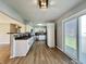 A sunlit kitchen with white cabinets, stainless appliances, and backyard access at 1210 W Grant St, Thorntown, IN 46071