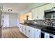 Open kitchen with stainless steel appliances, white cabinets, and convenient backyard access at 1210 W Grant St, Thorntown, IN 46071