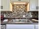 This is a detailed view of the kitchen backsplash, sink, and counter space at 1210 W Grant St, Thorntown, IN 46071