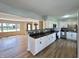 Open-concept home with living room and kitchen with white cabinets and tile backsplash at 1210 W Grant St, Thorntown, IN 46071