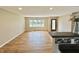 Inviting living room features pristine hardwood floors and ample natural light from a large window at 1210 W Grant St, Thorntown, IN 46071