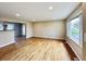 Inviting living room features pristine hardwood floors and ample natural light from a large window at 1210 W Grant St, Thorntown, IN 46071