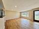 Inviting living room features pristine hardwood floors and ample natural light from a large window at 1210 W Grant St, Thorntown, IN 46071