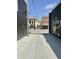 The back alley view features brick and black-painted buildings, including a pizza advertisement at 1210 W Grant St, Thorntown, IN 46071