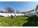 Expansive backyard setup with a fire pit, playground, patio, and a shade structure, ideal for outdoor living at 122 Stamford Dr, Pittsboro, IN 46167