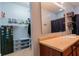 Bathroom featuring a single sink vanity, a large mirror, and a closet at 122 Stamford Dr, Pittsboro, IN 46167