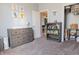 Cozy bedroom featuring neutral paint, a gray dresser, and cute wall decor at 122 Stamford Dr, Pittsboro, IN 46167