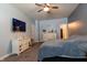 Spacious primary bedroom with a large window, a ceiling fan, and a dresser at 122 Stamford Dr, Pittsboro, IN 46167