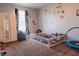 Bright bedroom with wall decals, a playpen, and a cozy beanbag chair at 122 Stamford Dr, Pittsboro, IN 46167