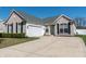 Beautiful home featuring a well-kept lawn, brick facade, attached garage, and tasteful landscaping at 122 Stamford Dr, Pittsboro, IN 46167