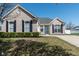 Charming brick home with a manicured lawn, dark shutters, and a pop of color on the front door at 122 Stamford Dr, Pittsboro, IN 46167