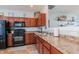 Functional kitchen featuring dark wood cabinets, modern appliances, and ample counter space for cooking at 122 Stamford Dr, Pittsboro, IN 46167