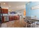 Eat-in kitchen featuring tile flooring, stainless steel appliances, and access to the living room at 122 Stamford Dr, Pittsboro, IN 46167
