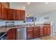 Kitchen featuring wood cabinets, tile flooring, stainless steel appliances and granite countertops at 122 Stamford Dr, Pittsboro, IN 46167