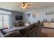 Open concept living room featuring carpet flooring, a ceiling fan, and a sliding glass door at 122 Stamford Dr, Pittsboro, IN 46167