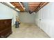 Unfinished basement area with concrete floor, exposed ceiling, and gray painted walls, offering potential for customization at 1229 Dallas Dr, Plainfield, IN 46168