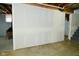 View of future bonus room area with drywall walls, concrete floors, and access to the stairs at 1229 Dallas Dr, Plainfield, IN 46168
