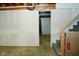 Unfinished basement with potential bonus area, concrete floors, and access to the stairs providing customizable potential at 1229 Dallas Dr, Plainfield, IN 46168