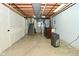 Unfinished basement area with concrete floors, and access to the stairs providing customizable potential at 1229 Dallas Dr, Plainfield, IN 46168