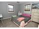 This bedroom features two windows for natural light, light-colored walls, and neutral carpet at 1229 Dallas Dr, Plainfield, IN 46168