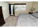 This bedroom features neutral carpet, a closet, and a large window for natural light at 1229 Dallas Dr, Plainfield, IN 46168