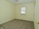 This bedroom features neutral carpeting, a window for natural light, and a spacious closet at 1229 Dallas Dr, Plainfield, IN 46168