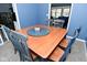 Dining area features wood table, gray and blue chairs, and view of the kitchen at 1229 Dallas Dr, Plainfield, IN 46168