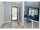 Entryway with wood floor, gray walls, and view into the living room and front yard at 1229 Dallas Dr, Plainfield, IN 46168