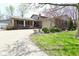 Inviting brick home with attached garage and a well-manicured front yard at 1229 Dallas Dr, Plainfield, IN 46168