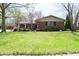 Charming brick home featuring a well-maintained lawn and blossoming trees at 1229 Dallas Dr, Plainfield, IN 46168