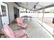Chairs and tables sit under a metal roof between the garage and privacy fence, creating an outdoor room at 1229 Dallas Dr, Plainfield, IN 46168