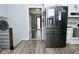 Kitchen view showcasing stainless steel fridge and access to hallway at 1229 Dallas Dr, Plainfield, IN 46168
