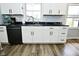 Close up showcasing the sleek black countertops and modern white cabinets at 1229 Dallas Dr, Plainfield, IN 46168