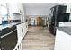 Bright kitchen features white cabinetry, black countertops, and stainless steel appliances at 1229 Dallas Dr, Plainfield, IN 46168