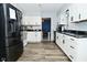 Spacious kitchen features modern appliances, white cabinetry, and open layout at 1229 Dallas Dr, Plainfield, IN 46168