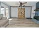 Living room featuring wooden barn doors and fireplace at 1229 Dallas Dr, Plainfield, IN 46168