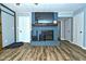A living room featuring a blue brick fireplace, modern flooring, and ample natural light at 1229 Dallas Dr, Plainfield, IN 46168