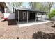 View of the outbuilding with metal roof, concrete patio, and sitting area in the backyard at 1229 Dallas Dr, Plainfield, IN 46168