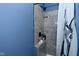 Modern gray tiled shower with a stylish shower head, storage niche, and a decorative shower curtain at 1229 Dallas Dr, Plainfield, IN 46168