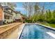 Backyard featuring a private pool, expansive patio area, and mature trees at 12613 Carrington Pl, Carmel, IN 46033